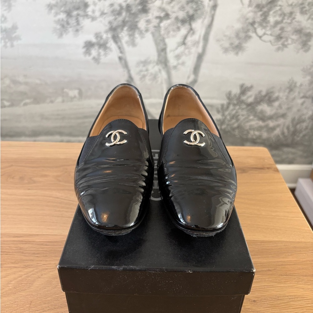 CHANEL Glossy Black Loafers with Silver Emblem